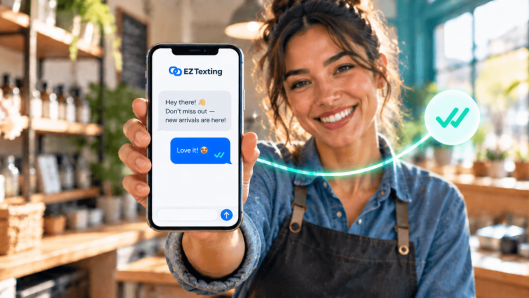 Smiling small-business owner holding a phone showing an EZ Texting message to customers, with a read-receipt checkmark